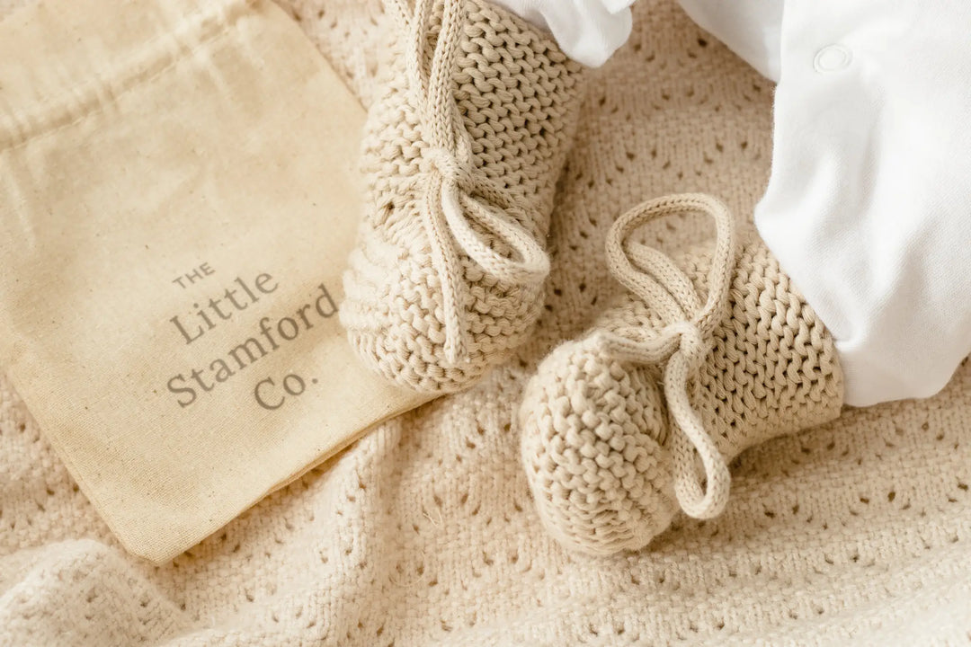 Bow knit newborn booties in gift bag