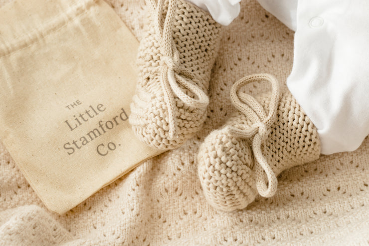 Bow knit newborn booties in gift bag